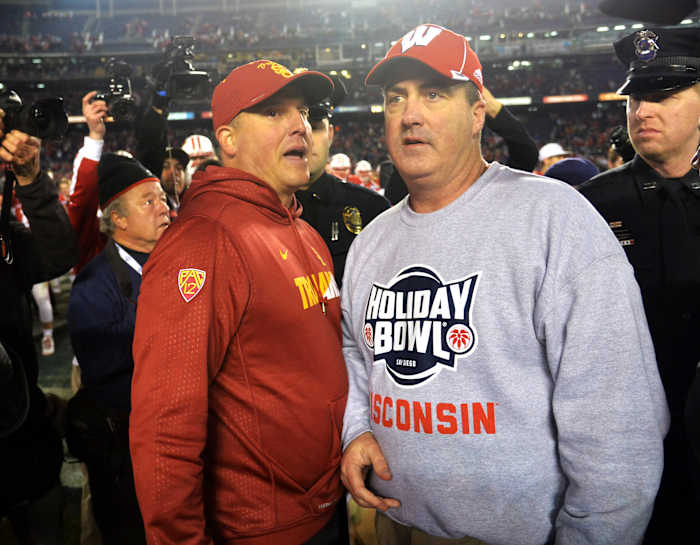 Paul Chryst speaking with USC head coach Clay Helton after the Holiday Bowl.